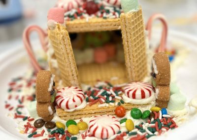 A whimsical gingerbread house embellished with bright icing and sweet treats.