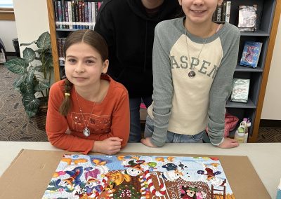 A cheerful family stands together, proudly displaying their completed puzzle while posing for a memorable photo.