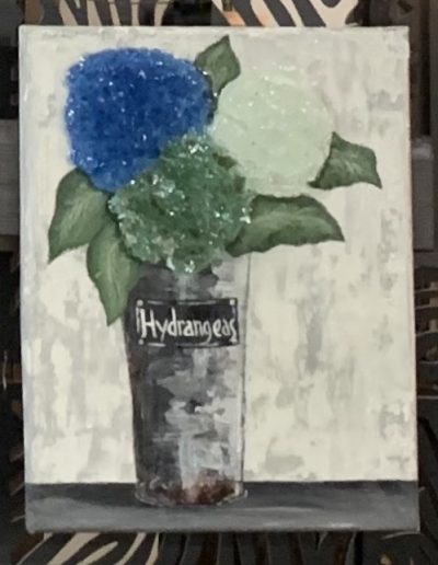 A painting depicting a vase filled with blue and green flowers, enhanced with crushed glass for texture and depth.